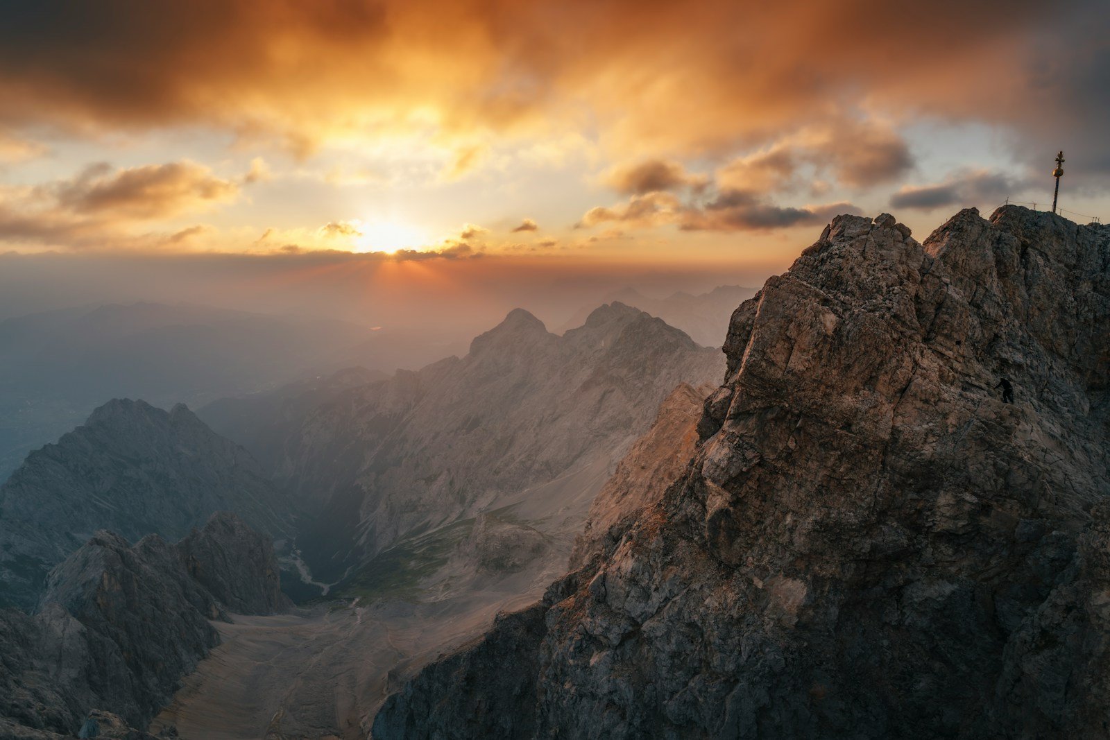 Majestic mountain peak at sunrise with dramatic clouds