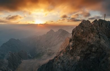 Majestic mountain peak at sunrise with dramatic clouds